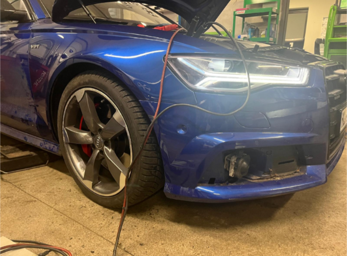 Niebieskie Audi podczas prac przy przednim zderzaku i instalacji